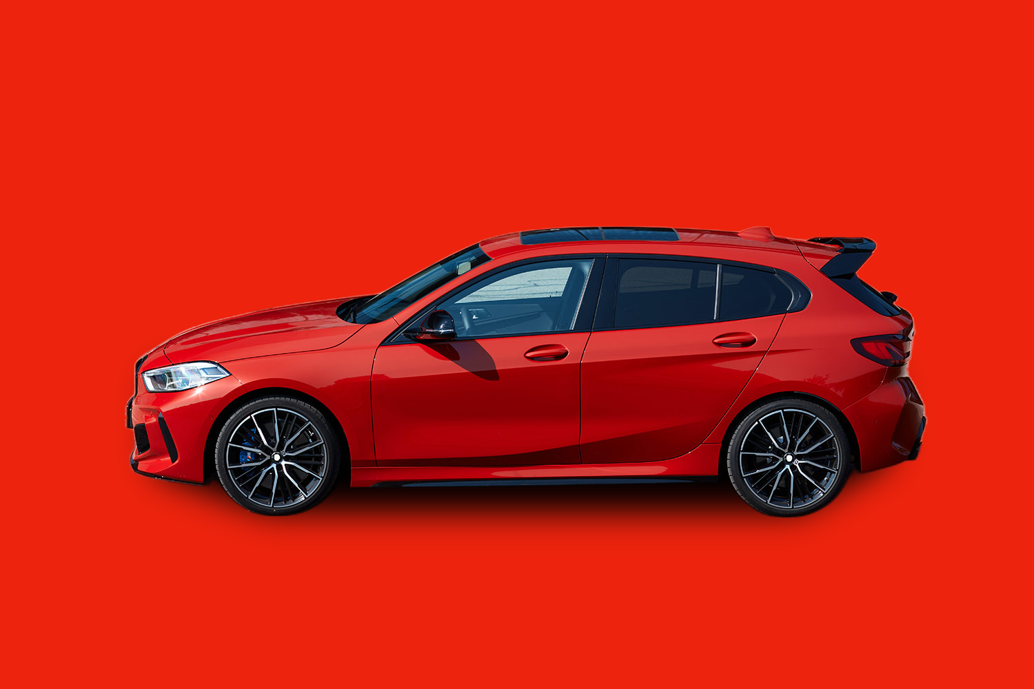The same hatchback cut out and placed on a solid brand-color background with a drop shadow